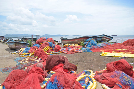 Fishing nets on the beach of Goa, India. Fishermen are preparing their nets for fishing.の写真素材