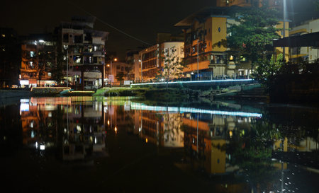 Reflection of buildings in the water at night in Hanoi, Vietnam