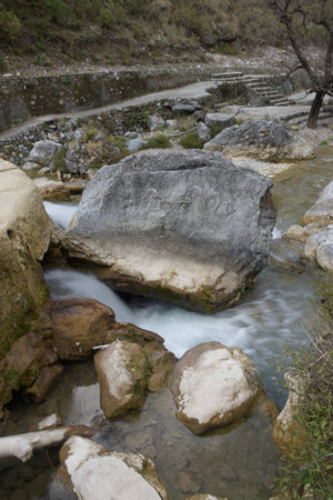 Mountain stream in the mountains. The river flows into the forest.の写真素材