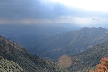 Mountains in the early morning with sunbeams coming through the clouds