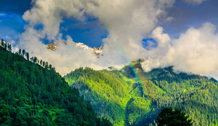Clouds, Rainbow and blue sky. Sunset in mountainの写真素材