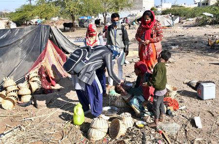 Beawar, Rajasthan, India, Feb. 01, 2021: An Anganwadi health worker administers polio vaccine drops to a child at a slum area during Pulse Polio eradication program in Beawar. Photo: Sumit Saraswatのeditorial素材
