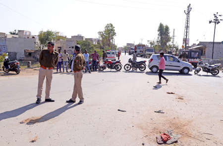 Beawar, Rajasthan, India, Feb. 6, 2021: Police stand guard on national highway 14 during nationwide chakka jam (roadblock-protest) to support ongoing agitation against government's farm reform laws, in Beawar. Protesters chanting slogans against Prime Minのeditorial素材