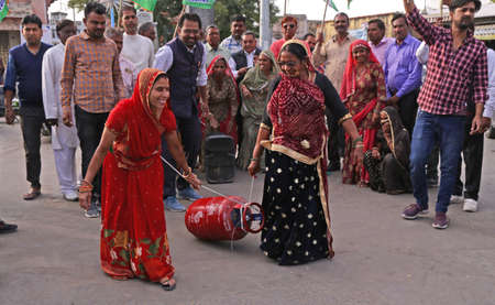 Beawar, Rajasthan, India, Feb. 15, 2021: Congress party activists demonstrate with gas cylinder during protest against Modi government after hike in fuel & LPG prices, in Beawar. Photo: Sumit Saraswatのeditorial素材