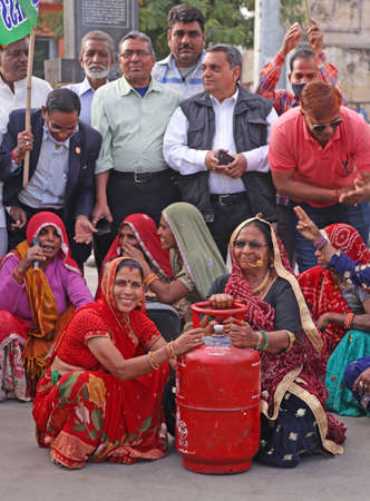 Beawar, Rajasthan, India, Feb. 15, 2021: Congress party activists demonstrate with gas cylinder during protest against Modi government after hike in fuel & LPG prices, in Beawar. Photo: Sumit Saraswatのeditorial素材