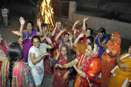 Beawar, Rajasthan, India, March 5, 2015: Hindu devotees dance around the bonfire during Holika Dahan on Holi, the spring festival of colours, in Beawar. Photo: Sumit Saraswatのeditorial素材