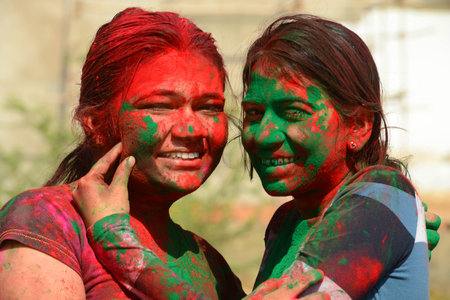 Beawar, Rajasthan, India, March 2, 2018: Indian girls apply colored powder 'gulal' on each other to celebrate Holi, the spring festival of colours, in Beawar. Photo: Sumit Saraswatのeditorial素材