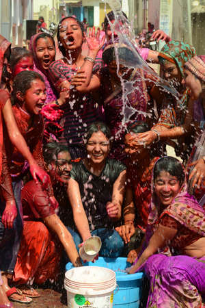 Beawar, Rajasthan, India, March 2, 2018: Indian women play with colors and water as they celebrate Holi, the spring festival of colours, in Beawar. Photo: Sumit Saraswatのeditorial素材