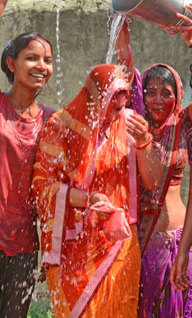 Beawar, Rajasthan, India, March 2, 2018: Indian women play with colors and water as they celebrate Holi, the spring festival of colours, in Beawar. Photo: Sumit Saraswatのeditorial素材