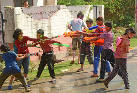 Beawar, Rajasthan, India, March 2, 2018: Children play with colors as they celebrate Holi, the spring festival of colours, in Beawar. Photo: Sumit Saraswatのeditorial素材