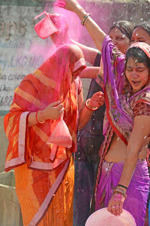 Beawar, Rajasthan, India, March 2, 2018: Indian women play with colors and water as they celebrate Holi, the spring festival of colours, in Beawar. Photo: Sumit Saraswatのeditorial素材