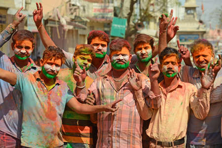 Beawar, Rajasthan, India, March 2, 2018: Youngsters paint tricolor of Indian flag on their face as they celebrate Holi, the spring festival of colours, in Beawar. Photo: Sumit Saraswatのeditorial素材