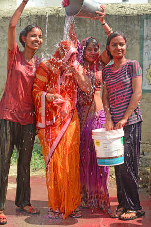 Beawar, Rajasthan, India, March 2, 2018: Indian women play with colors and water as they celebrate Holi, the spring festival of colours, in Beawar. Photo: Sumit Saraswatのeditorial素材