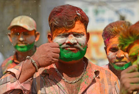 Beawar, Rajasthan, India, March 2, 2018: Youngster paint tricolor of Indian flag on their face as they celebrate Holi, the spring festival of colours, in Beawar. Photo: Sumit Saraswatのeditorial素材