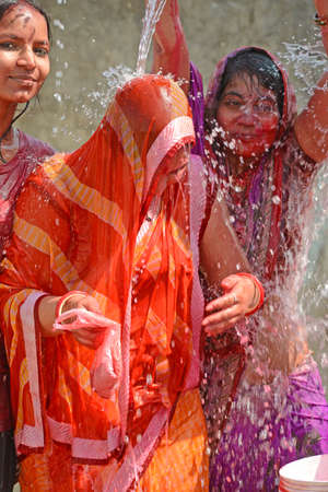 Beawar, Rajasthan, India, March 2, 2018: Indian women play with colors and water as they celebrate Holi, the spring festival of colours, in Beawar. Photo: Sumit Saraswatのeditorial素材