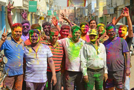 Beawar, Rajasthan, India, March 2, 2018: Indian people poses for a photograph as their face is painted with colored powder on Holi, the spring festival of colours, in Beawar. Photo: Sumit Saraswatのeditorial素材