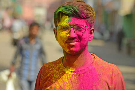 Beawar, Rajasthan, India, March 2, 2018: Portrait of Indian young man with full of colored powder 'gulal' on Holi, the spring festival of colours, in Beawar. Photo: Sumit Saraswatのeditorial素材