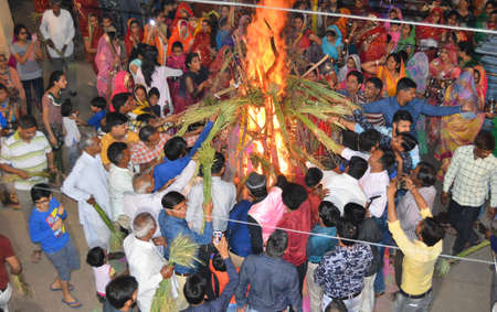 Beawar, Rajasthan, India, March 1, 2018: Hindu devotees perform rituals around bonfire during Holika Dahan on the eve of Holi, the spring festival of colours, in Beawar. Photo: Sumit Saraswatのeditorial素材