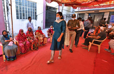 Beawar, Rajasthan, India, March 2, 2021: Senior citizens wait for their turn to receive a dose of COVID-19 vaccine, during countrywide inoculation drive, at a hospital in Beawar. Photo: Sumit Saraswatのeditorial素材