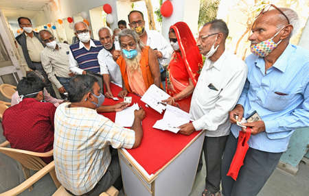 Beawar, Rajasthan, India, March 2, 2021: Senior citizens wait for their turn to receive a dose of COVID-19 vaccine, during countrywide inoculation drive, at a hospital in Beawar. Photo: Sumit Saraswatのeditorial素材