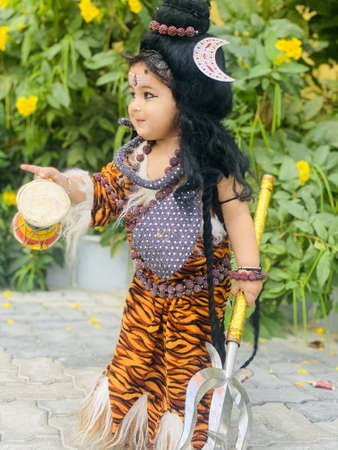 Beawar, Rajasthan, India, March 10, 2021: A child dressed as Hindu Lord Shiva ahead of a religious event Maha Shivratri festival in Beawar. Photo: Sumit Saraswatのeditorial素材