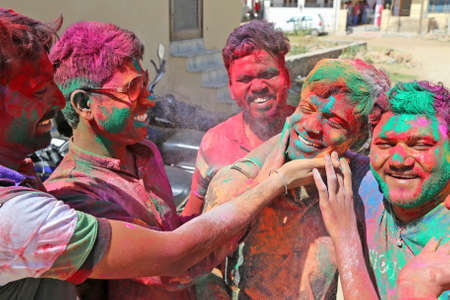 Beawar, Rajasthan, India, March 24, 2016: Indian boys apply colored powder 'gulal' on each other to celebrate Holi, the Hindu spring festival of colours, in Beawar. Photo: Sumit Saraswatのeditorial素材
