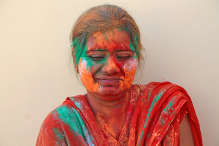 Beawar, Rajasthan, India, March 24, 2016: Portrait of Indian young woman smeared in color powder celebrate Holi, the Hindu spring festival of colors, in Beawar. Photo: Sumit Saraswatのeditorial素材