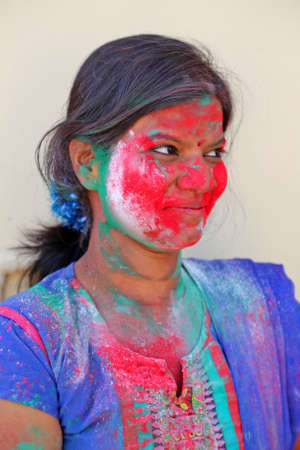 Beawar, Rajasthan, India, March 24, 2016: Portrait of Indian young woman smeared in color powder celebrate Holi, the Hindu spring festival of colors, in Beawar. Photo: Sumit Saraswatのeditorial素材