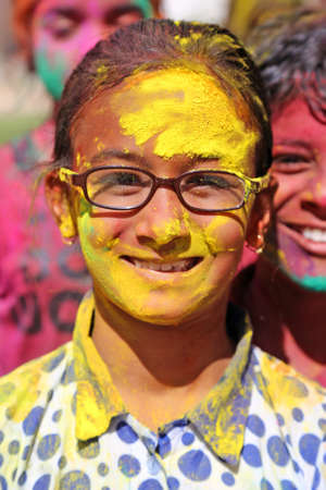 Beawar, Rajasthan, India, March 24, 2016: Portrait of Indian girl smeared in color powder celebrate Holi, the Hindu spring festival of colors, in Beawar. Photo: Sumit Saraswatのeditorial素材