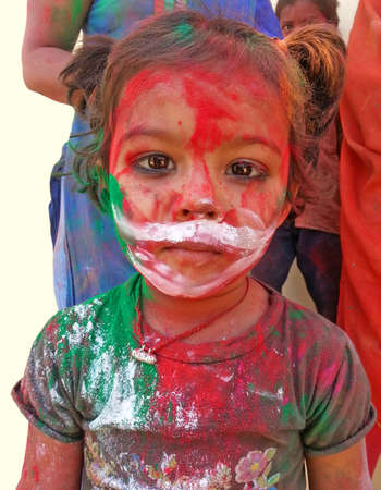 Beawar, Rajasthan, India, March 24, 2016: Portrait of Indian girl child smeared in color powder celebrate Holi, the Hindu spring festival of colors, in Beawar. Photo: Sumit Saraswatのeditorial素材