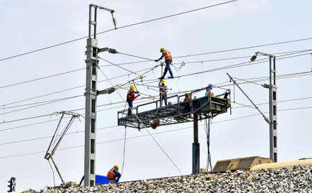 Beawar, Rajasthan, India, March 16, 2021: Workers test electric wires on the Delhi-Mumbai railway corridor, in Beawar. Photo: Sumit Saraswatのeditorial素材