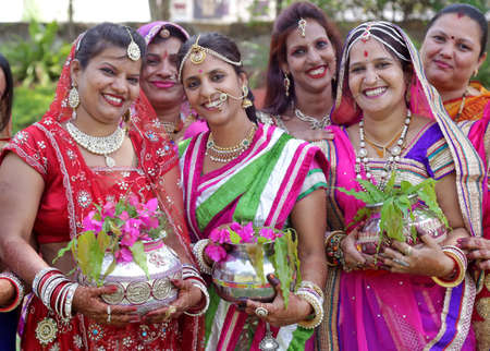 Beawar, Rajasthan, India, April 9, 2016: Hindu rajasthani women carrying water urns for worship to Lord Shankar and Goddess Parvati on Gangaur festival in Beawar. Photo: Sumit Saraswatのeditorial素材