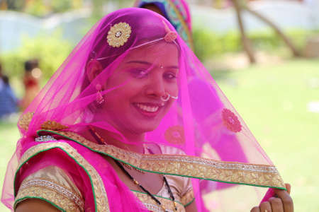 Beawar, Rajasthan, India, April 9, 2016: Portrait of a smiling rajasthani young woman in traditional attire poses for a picture during Gangaur festival celebrations in Beawar. Photo: Sumit Saraswatのeditorial素材