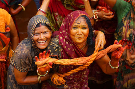 Beawar, Rajasthan, March 25,2016: Women of Jingar community celebrate Kodamar Holi festival in Beawar. Women dip ropes in colored water before using them to playfully beat men. Photo: Sumit Saraswatのeditorial素材