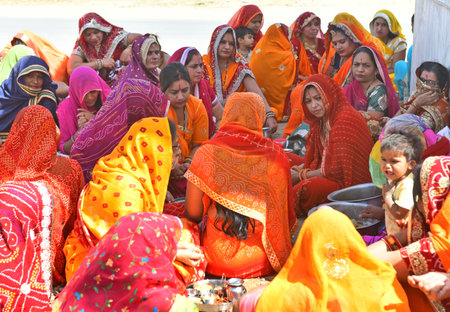 Beawar, Rajasthan, India, April 6,2021: Rajasthani women heard religious story after perform rituals at peepal tree during Dasha Mata Pujan amid spike in coronavirus cases. Photo: Sumit Saraswatのeditorial素材