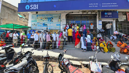 Beawar, Rajasthan, India, May 3, 2021: Elderly people stand in long queues outside State Bank of India for their pension payment, amid surge in coronavirus cases, in Beawar. Photo: Sumit Saraswatのeditorial素材
