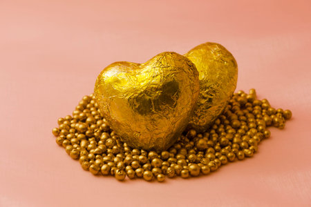 Golden colored hearts with pearls for Valentines Day and love conceptの写真素材