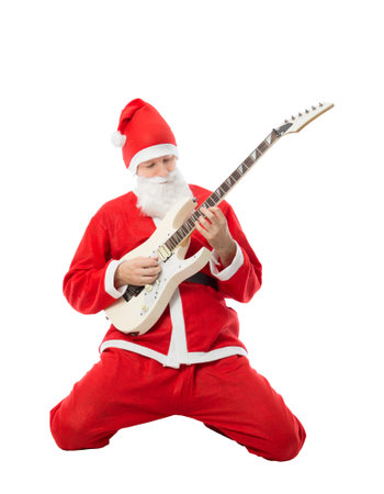 Christmas male guitarist with Santa Claus costume playing a white e-guitarの写真素材