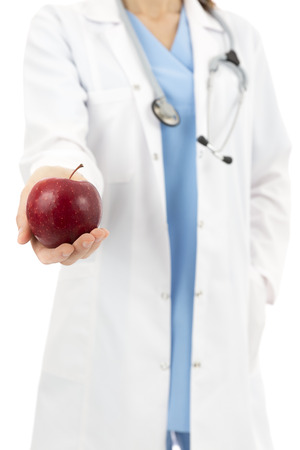 Doctor offering appleの写真素材