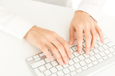 Business woman hands on a keyboardの写真素材
