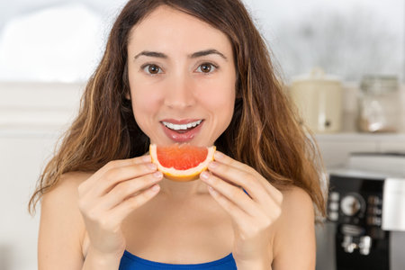 Woman eating a slice of fruit