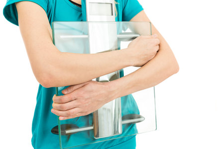 Diet woman holding scaleの写真素材