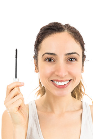 Woman showing mascara brush