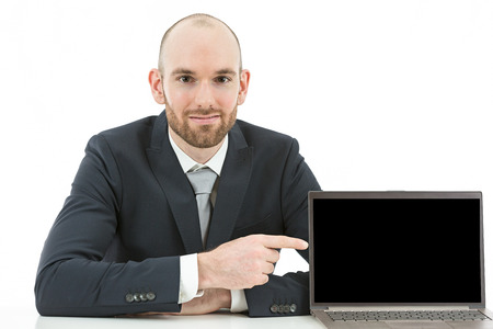 Caucasian business man showing copy space on his laptop screen. Isolated on white background.の写真素材