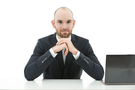 Caucasian friendly business man at theoffice with his comouter on the desk. Isolated on white background.の写真素材