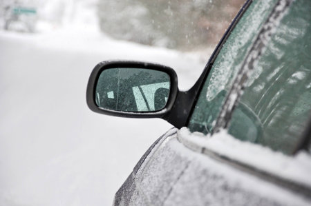 blue car in snow on the road