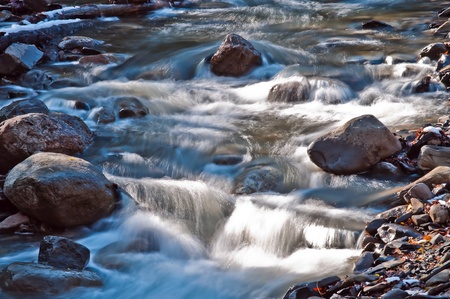 A babbling brook wanders past rocks in upstate New Yorkの写真素材