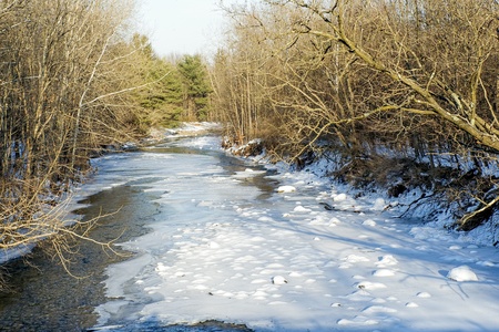 Snow and ice cover the Normans Kill Creek in Princetown, New Yorkの写真素材