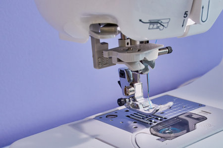 Closeup of a sewing machine head with a sewing needle