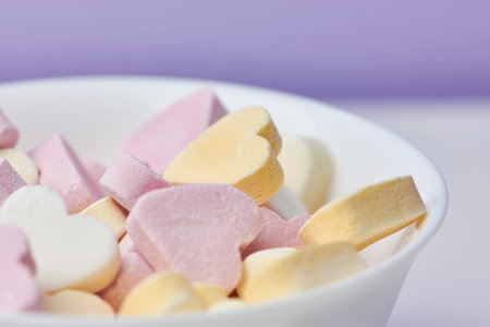 macro color picture of candy hearts in a white bowl